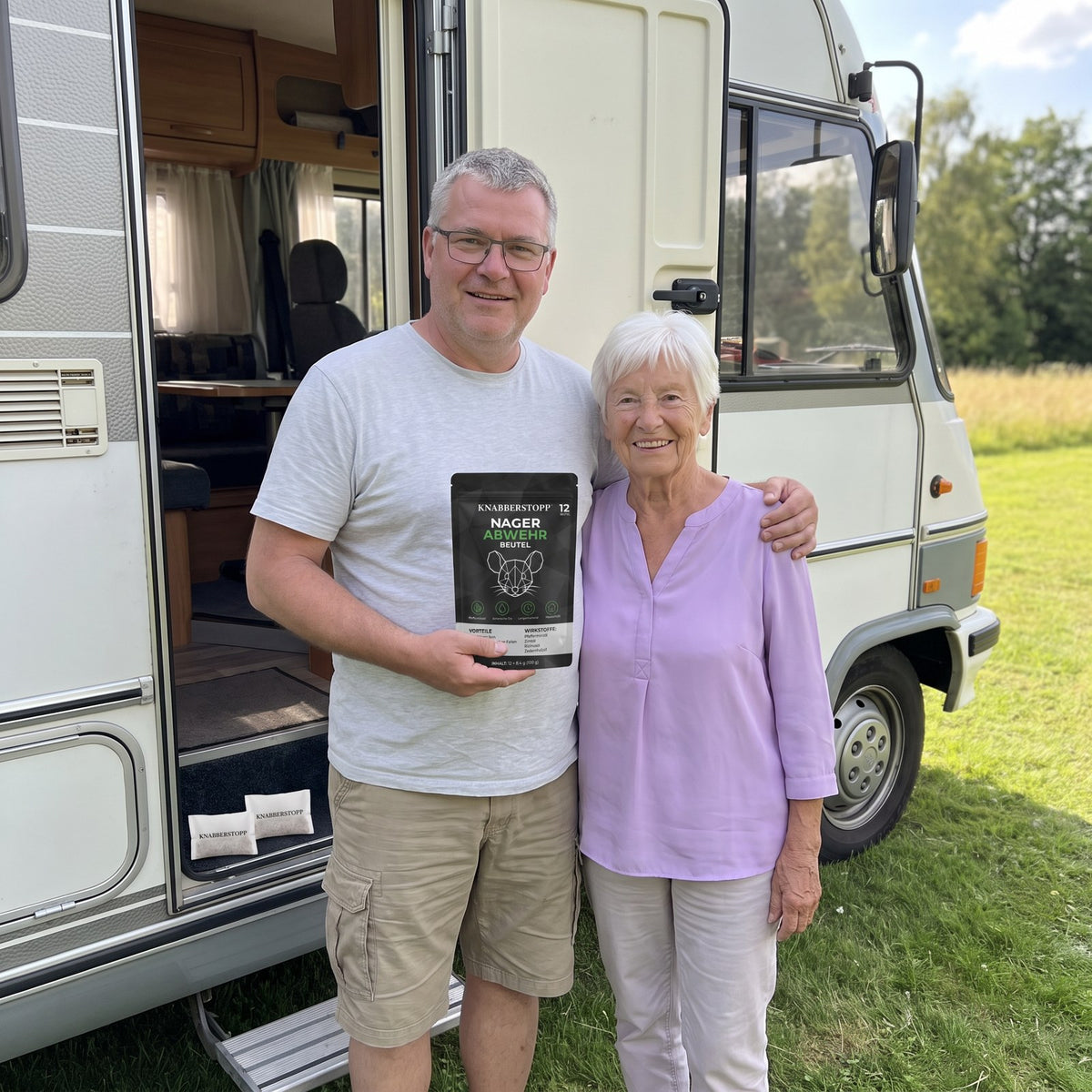 Couple in front of their motorhome at a campsite with a pack of rodent repellent pouches